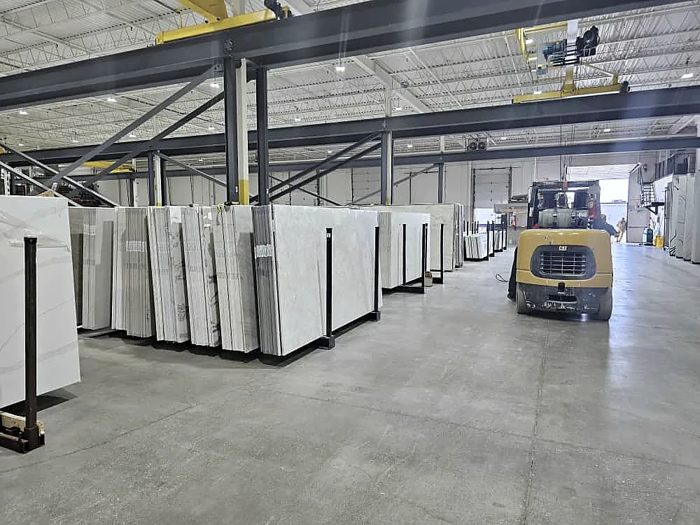 Stone slabs standing on A-frames in a distributor's warehouse